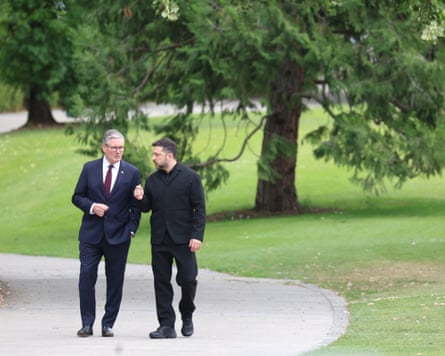 Starmer and Zelenskyy walk and talk in a parkland setting