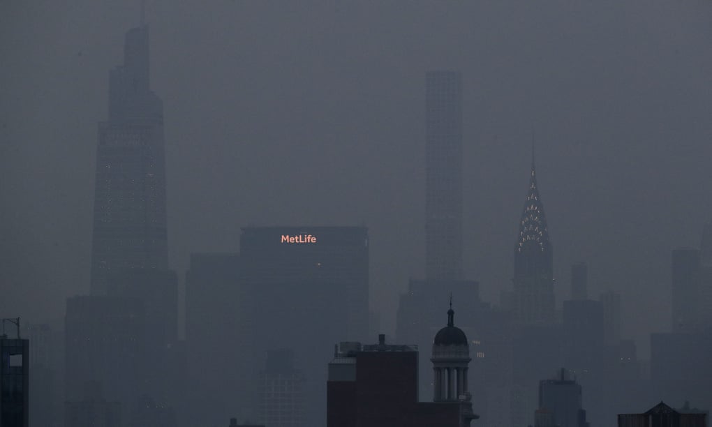 The Met Life and Chrysler buildings glow through a thick haze hanging over Manhattan, on Tuesday, in New York.