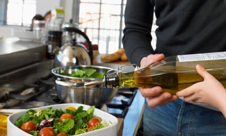 Olive oil being poured on to a salad