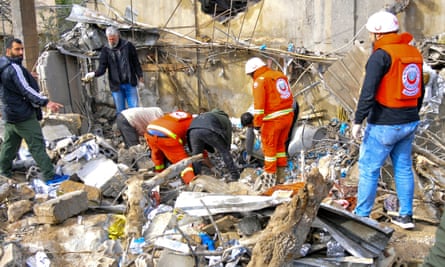 Rescue workers inspect a bomb blast.