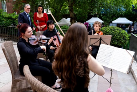 Musical shoots … Keir Starmer watches Guildhall School musicians at a 10 Downing Street reception in 2025.