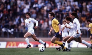 Valencia’s Mario Kempes is hot on the heels of Liam Brady as the Arsenal player surges forward.