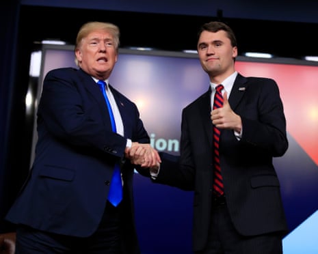 Donald Trump shakes hands with Charlie Kirk at a 2018 event.