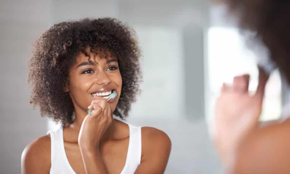 Young woman brushing her healthy white teeth