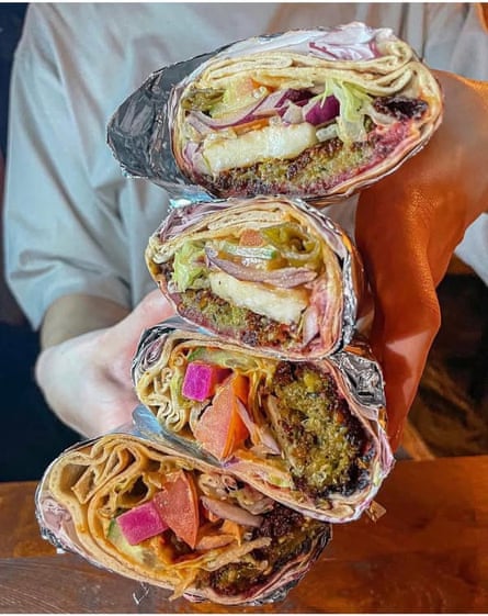 wraps stuffed full of falafels, lettuce, tomato, pickled beetroot and many other delicious things