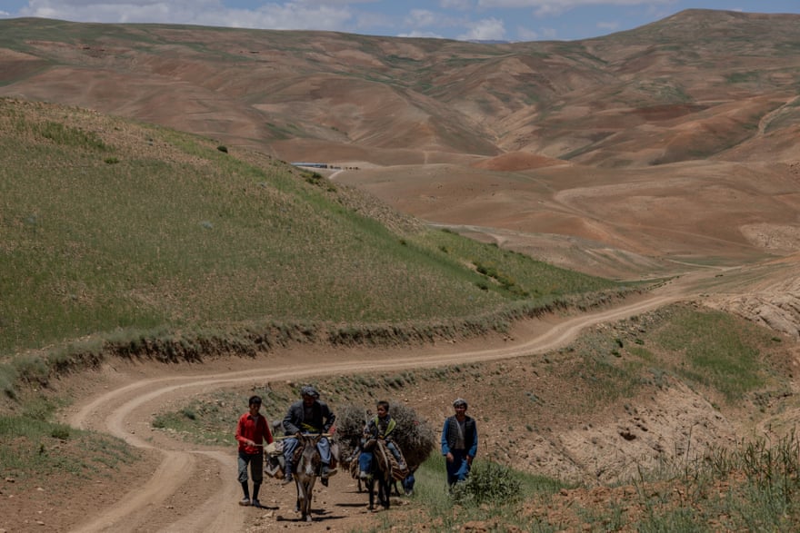 Farmers walking home in rural Bamyan. Most people in the country live below the poverty line after development funds were halted and Afghan funds frozen in US accounts.