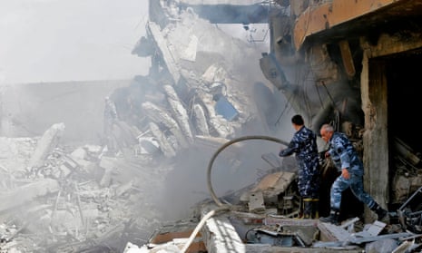 Syrian soldiers inspect the wreckage of a building described as part of the Scientific Studies and Research Centre compound in the Barzeh district, north of Damascus.