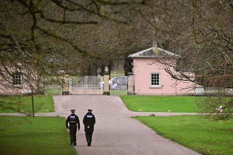 Police officers walk towards the entrance to Royal Lodge, a 30-room property and former residence to Britain's former prince Andrew where police said they are still conducting a search, in Windsor.