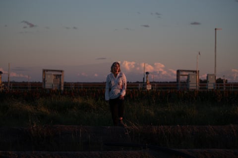 Zena Ronnfeldt in front of one of the CSG wells drilled in 2018 under her property ‘Bogaroo’ at Kupunn
