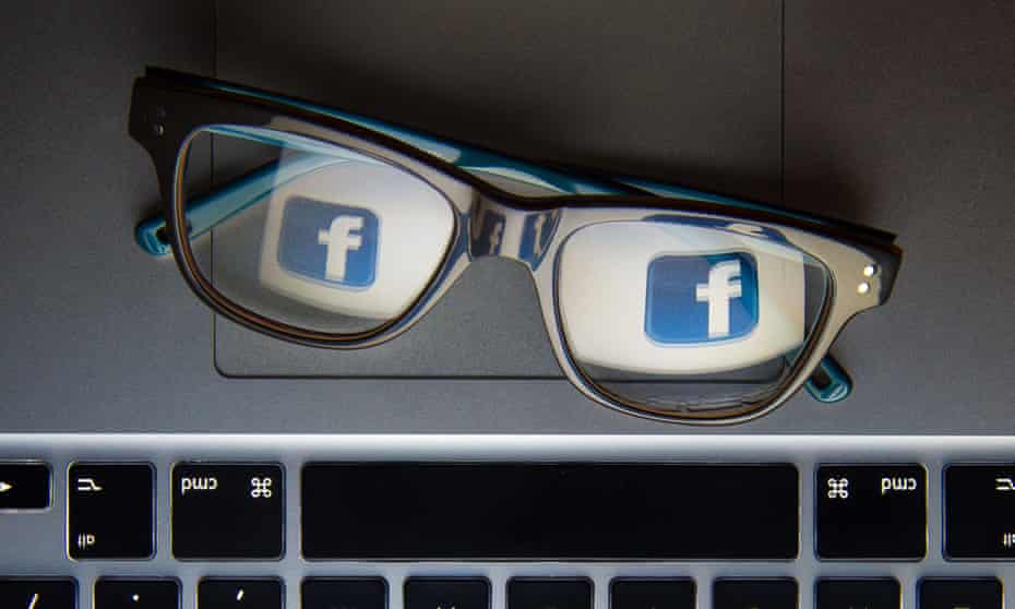 Facebook’s logo reflected in a pair of glasses