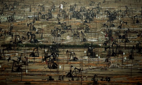 Oil pumping jacks and drilling pads at the Kern River oil field in Bakersfield, California.