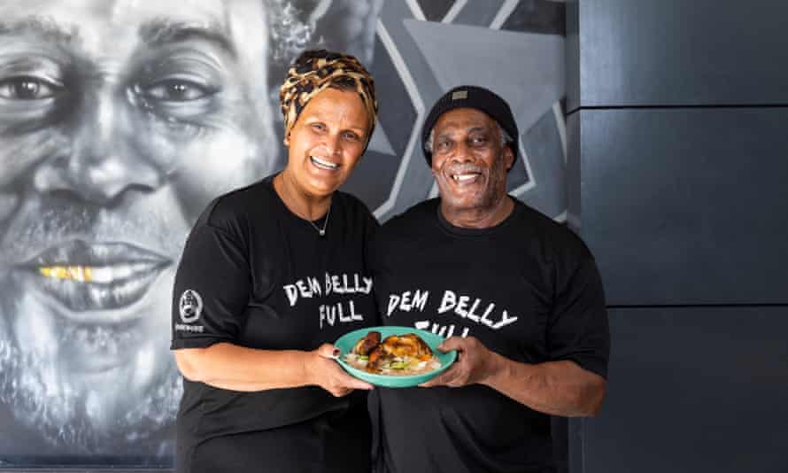 Farida and Buzzrock Anderson. chefs/owners of Buzzrocks in Manchester, with their signature barbecue jerk chicken with rice and peas