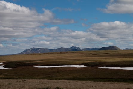 The Brooks Range peeks out from behind the sprawling tundra of northern Alaska The Brooks Range peeks out from behind the sprawling tundra of northern Alaska