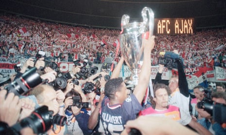 Patrick Kluivert presents the Champions League trophy to the crowd.