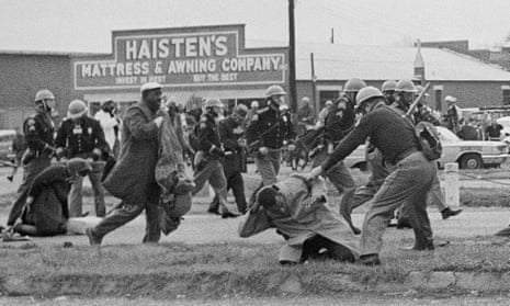 On 7 March 1965, a state trooper swings a billy club at John Lewis, chairman of the Student Nonviolent Coordinating Committee, during a civil rights voting march in Selma, Alabama.