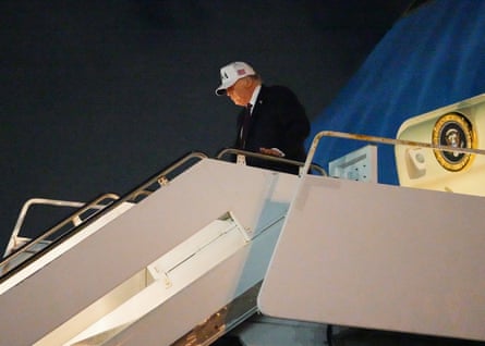 Man in white cap starts walking down plane ramp