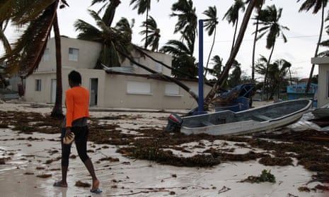 A woman walks among debris on the seashore in the aftermath of Hurricane Maria in Punta Cana, Dominican Republic.