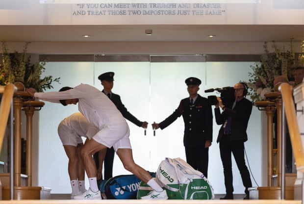 Tom Jenkins’ best shots of Wimbledon 2022 – in pictures | Wimbledon 2022 20 Novak Djokovic leans on a bannister in the clubhouse to stretch his calves just before he goes through the doors onto Centre Court for his second round match with Thansi Kokkinakis.