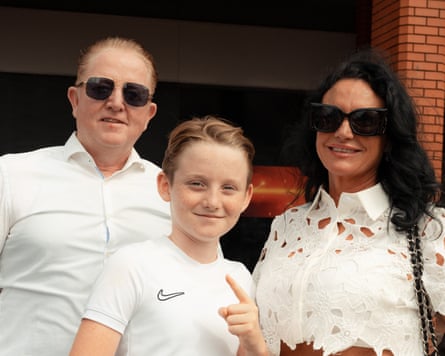 The family pose together, all wearing white
