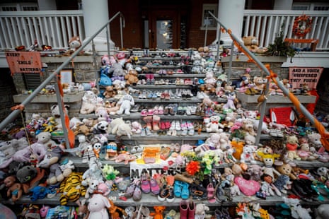 Children’s shoes and stuffed animals sit on the steps as a tribute to those missing from the former Mohawk Institute Residential School, in Brantford, Canada