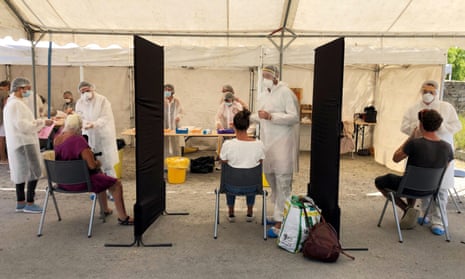 Healthcare workers collect samples in a walk-through test site in Quiberon, France.