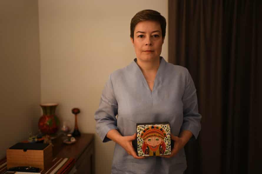 Solomiya Rozhko standing in her mother’s apartment holding a picture