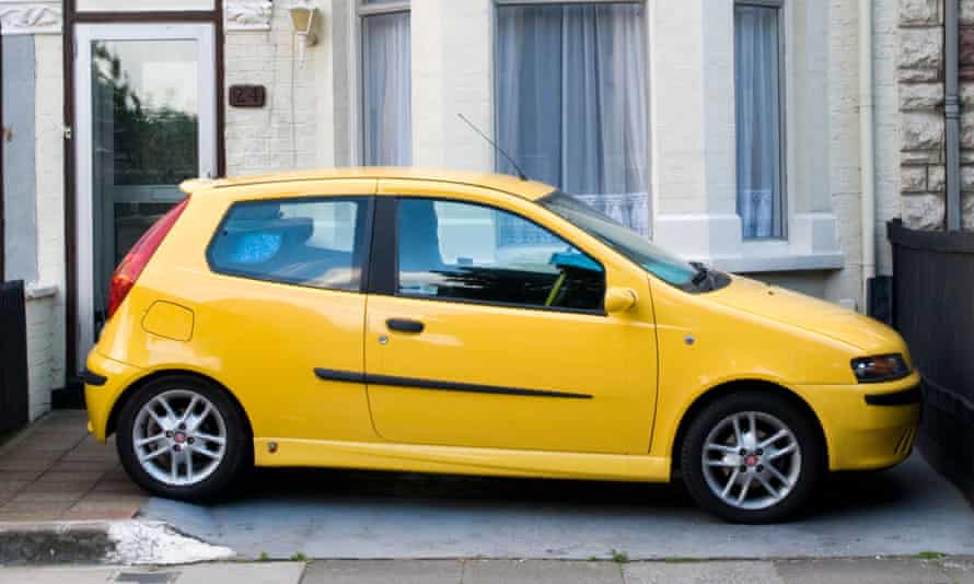 Car parked in front garden of terraced house
