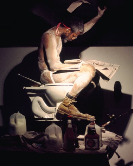 A man reading a newspaper while sitting on a toilet.