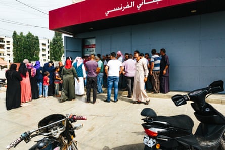 People queuing for an ATM machine in the town of Akkar, in Lebanon, on 14 July.