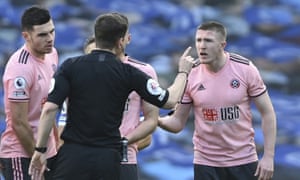 Sheffield United’s John Lundstram protests but Peter Bankes sends him off for a foul on Brighton’s Joël Veltman