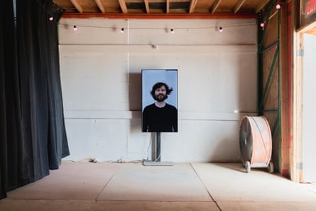 Man on a large screen inside