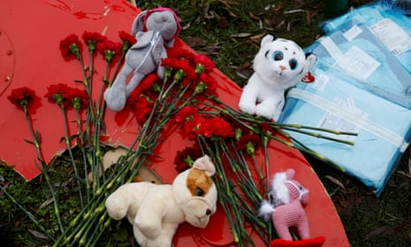 Tributes are left at the site of a helicopter crash in the town of Brovary, outside Kyiv.
