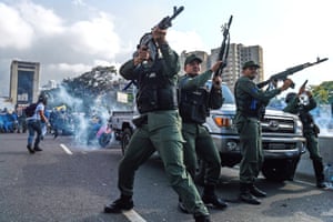 Members of the Bolivarian National Guard fire into the air to repel forces loyal to Nicolás Maduro