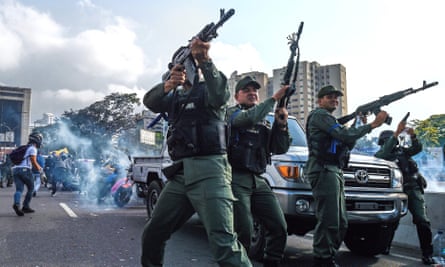 Members of the Bolivarian national guard who joined the self-proclaimed acting president Juan Guaidó fire into the air near La Carlota military base in Caracas on Tuesday.