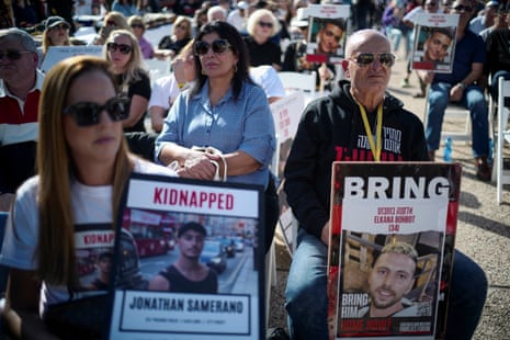 People hold posters during a religious ceremony to pray for hostages kidnapped on the deadly 7 October attack by Hamas in Tel Aviv, Israel.