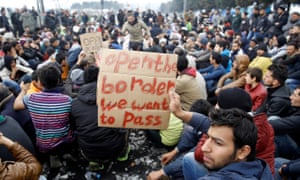 Refugees hold banners during a protest demanding the opening of the borders. 