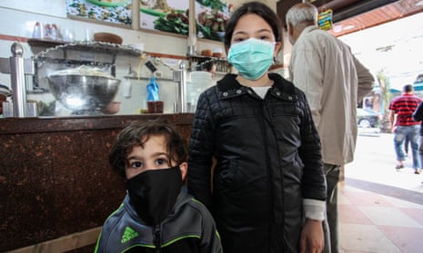 Palestinian children wearing protective face masks