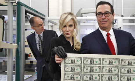 Treasury secretary Steven Mnuchin and his wife Louise Linton hold up a sheet of new dollar bills at the Bureau of Engraving and Printing in Washington.