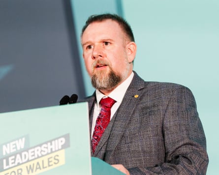 Peredur Owen Griffiths speaks from behind a lectern