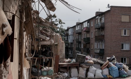 Residential building struck by a Russian attack: piles of possessions are seen by a ruined building with damaged concrete and destroyed walls