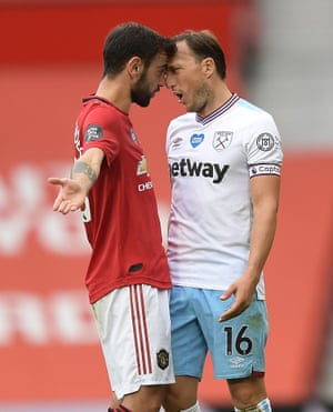 Bruno Fernandes and Mark Noble square up.