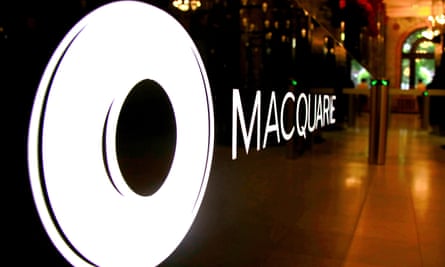 Macquarie logo and circular badge in an illuminated display, seen from an acute angle