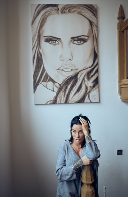 Price stands beneath a giant charcoal drawing of her own face
