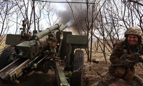 A Ukrainian soldier fires the howitzer at the Russian positions on the frontline in Luhansk.