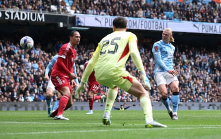 Erling Haaland scores Manchester City’s 4th extremity past Virgil van Dijk and Giorgi Mamardashvili to complete his hat-trick.