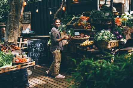 A market stall full of vegetables with a sign saying ‘Farm fresh produce’