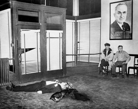 black and white picture of man lying on floor