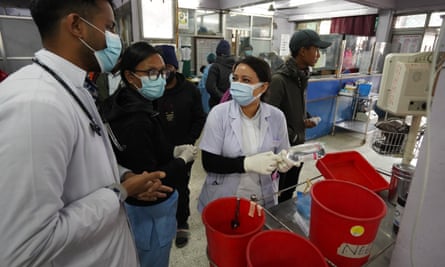 Nurse Shalu Chand, right, at work in the emergency department at Bir hospital in Kathmandu.