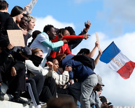 Youths climb the Column of July monument during a demonstration in Paris.