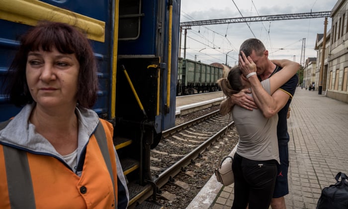 Yulya, 33, and Roman, 36, say goodbye to each other as Yulya departs on a train and Roman’s rotation to the frontline begins.